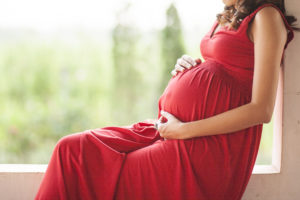 Image of pregnant woman touching her belly.